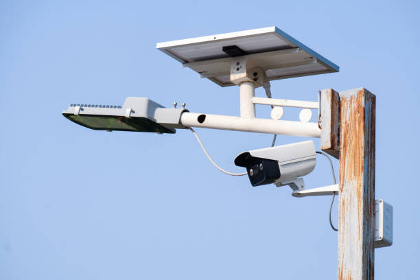 CCTV and illumination with solar panel on the post CCTV and illumination with solar panel on the post night vision security camera stock pictures, royalty-free photos & images