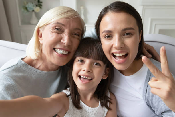 istock Overjoyed three generations of women take selfie together 1208992186