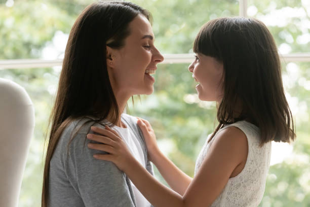 istock Overjoyed little daughter feel happy talking with mom 1208992217