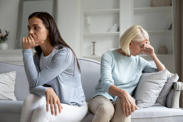 istock Thoughtful adult mom and daughter avoid talking after quarrel 1208992220