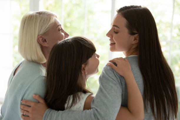 istock Happy three generations of women hug showing unity 1208992224