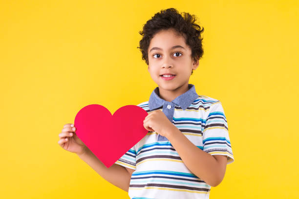 istock Black ethnicity child boy isolated on yellow background 1208993500
