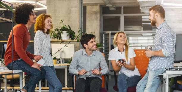 istock Friendly young business team chatting during coffee break 1208994873