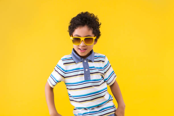 istock Black ethnicity child boy isolated on yellow background 1208994910