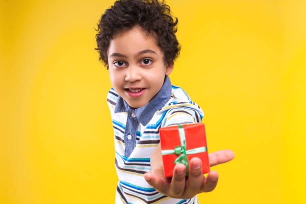 istock Black ethnicity child boy isolated on yellow background 1208994971