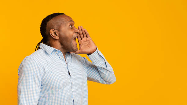 istock Mature african man shouting aside at free space 1208995436