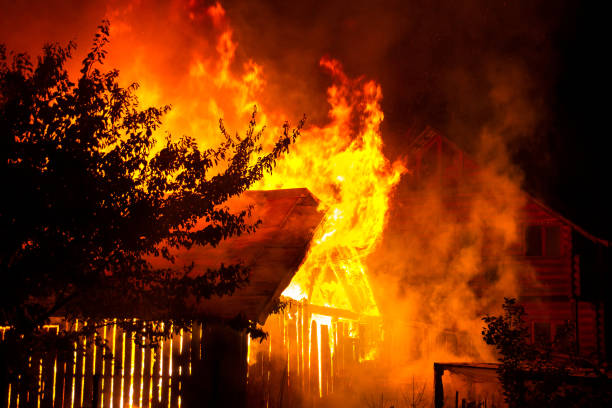 istock Wooden house or barn burning on fire at night. 1208997442
