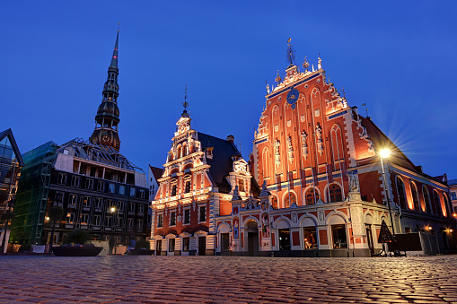 Riga Town Hall Square at city center with House of the Blackheads during twilight dusk in Latvia, Europe