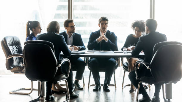 istock Confident businessman speaks diverse employees about project. 1208998475