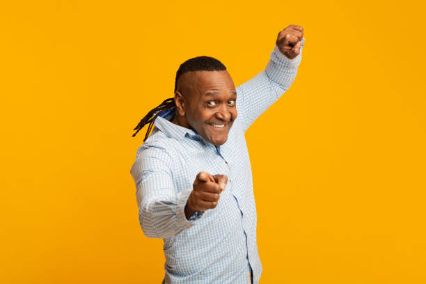 istock Positive african american mature man pointing at camera 1209004212