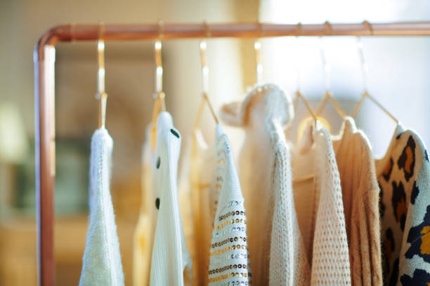 istock Closeup on modern copper clothes rack with clothes on hangers 1209004589