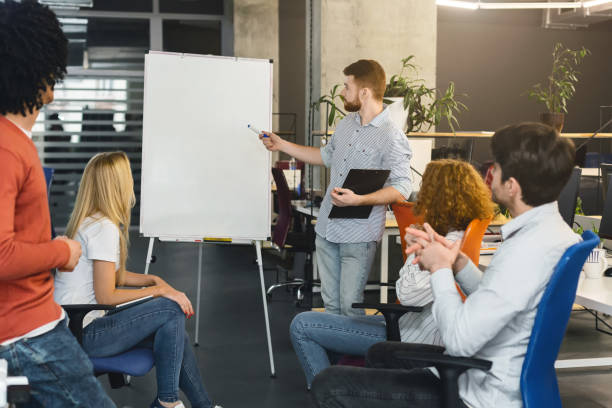 istock Young man presenting new marketing plan to creative team 1209006743