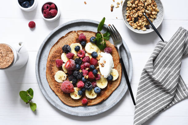 crepe with berries and yogurt for breakfast. breakfast on the kitchen table top view. - strawberry blueberry raspberry glass imagens e fotografias de stock