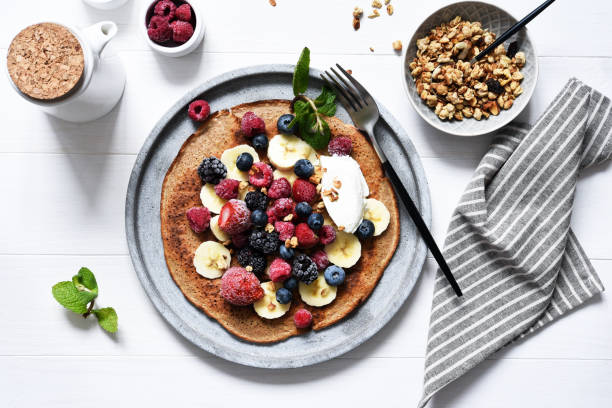 istock Crepe with berries and yogurt for breakfast. Breakfast on the kitchen table top view. 1209008584