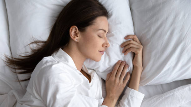 istock Serene beautiful woman sleeping on soft pillow close up 1209008700
