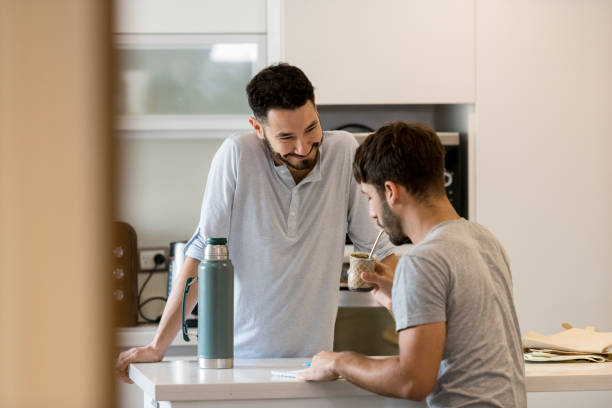 istock Happy couple drinking tea and writing list together 1209009421