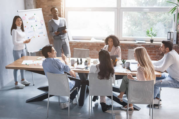 istock Cheerful international colleagues having business presentation in office 1209009443