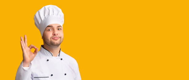 istock Professional Chef Gesturing OK Posing On Yellow Background, Panorama 1209011261