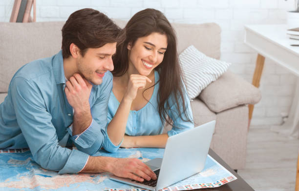 istock Loving couple searching best tour, preparing for vacation 1209011585