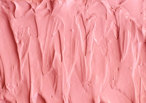 istock Pale pink cosmetic clay (rhassoul, facial mask, face cream, body wrap) texture close up, selective focus. Abstract background with brush strokes. 1209011779
