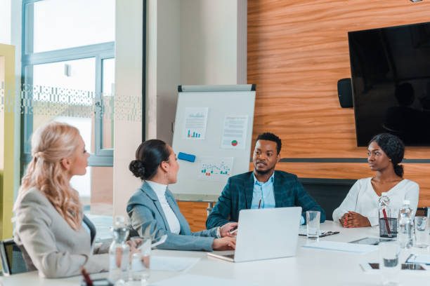 istock young multicultural businesspeople having meeting while sitting in conference hall 1209011970