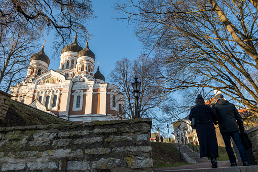 An older couple walks up Toompea Hill in the Estonian city of Tallinn, near Alexander Nevsky Cathedral, a large Russian Orthodox church completed in 1900, when Estonia was part of the Czarist Empire.  (February 24, 2020)