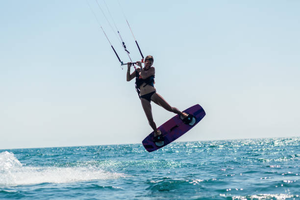 istock Fit young woman kite boarding 1209014287