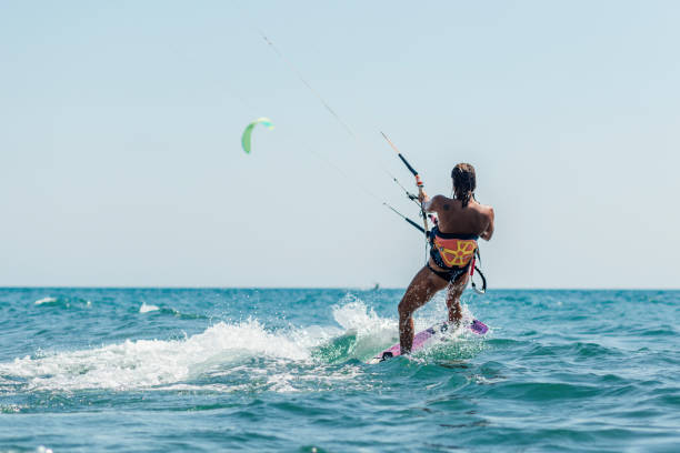 istock Fit young woman kite boarding 1209014322