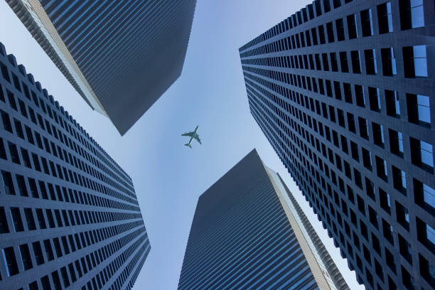istock A plane flies over a commercial building 1209014748