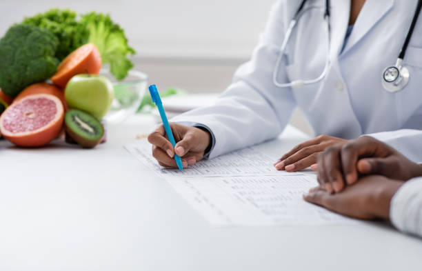 istock Nutritionist making treatment plan for patient at clinic 1209016417