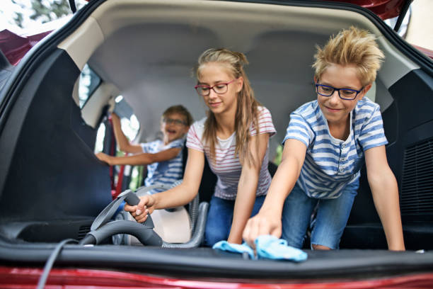 istock Three kids cleaning car interior 1209017280