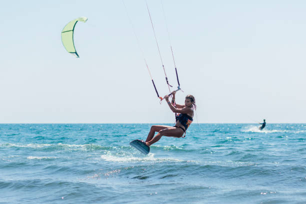 istock Fit young woman kite boarding 1209017477