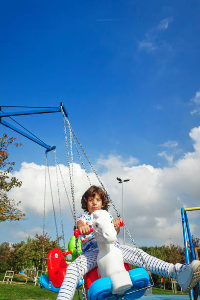 istock Happy little boy laughing at the playground 1209018895