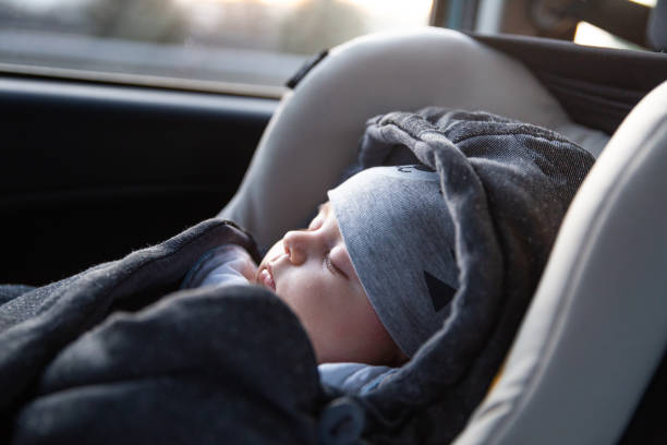 Family travel Inside of the car, baby sleeping in a car seat. baby stroller winter stock pictures, royalty-free photos & images