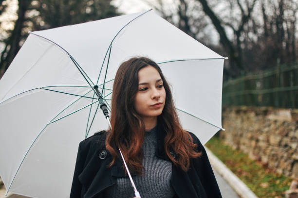 istock Beautiful young woman enjoying a rainy day 1209020143