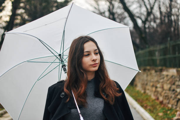 istock Beautiful young woman enjoying a rainy day 1209020185