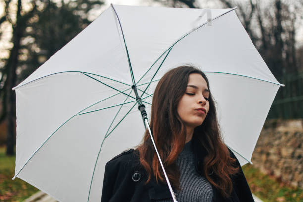 istock Beautiful young woman enjoying a rainy day 1209020344