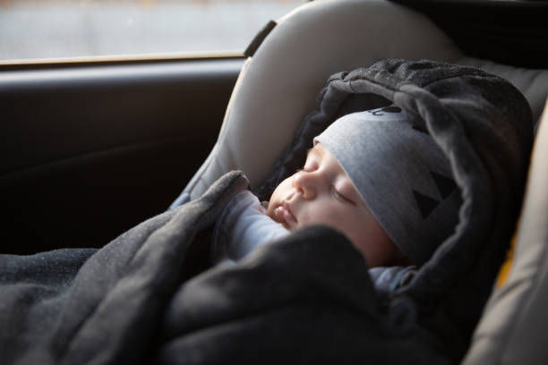 Family travel Inside of the car, baby sleeping in a car seat. baby stroller winter stock pictures, royalty-free photos & images