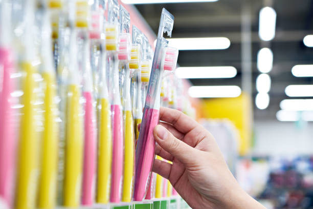 Toothbrush in package in hand in store stock photo