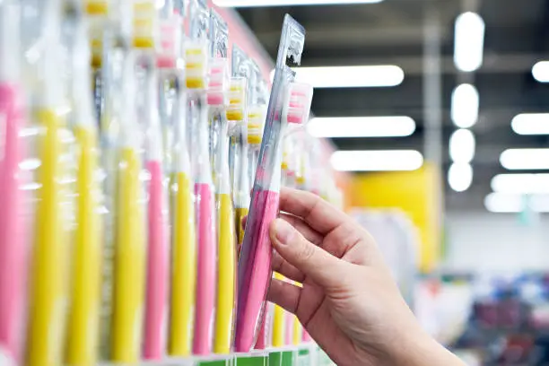 Photo of Toothbrush in package in hand in store