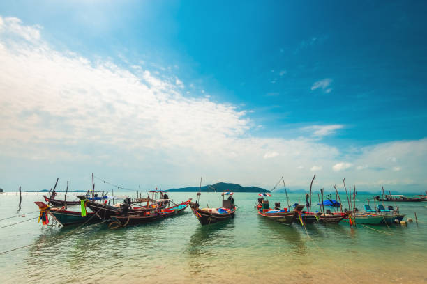 Ko Samui, Thailand - January 2, 2020: Authentic Thai fishing boats docked at Thong Krut beach in Taling Ngam on a bright day