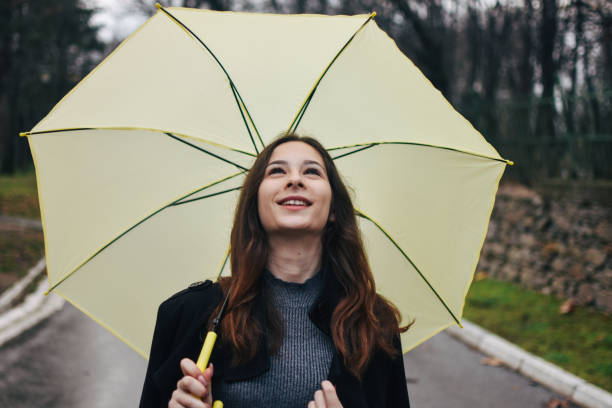 istock Beautiful young woman enjoying a rainy day 1209022031