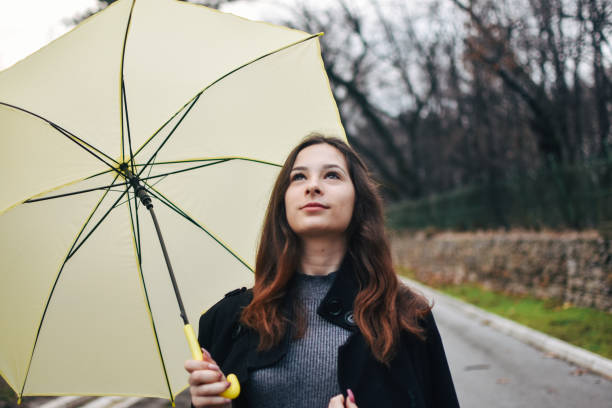 istock Beautiful young woman enjoying a rainy day 1209022064