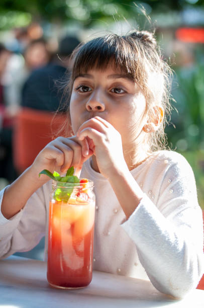 istock Cute girl drinking cocktail 1209025678