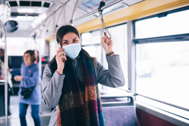 istock Young Woman With Face Mask Talking On The Phone. 1209025687