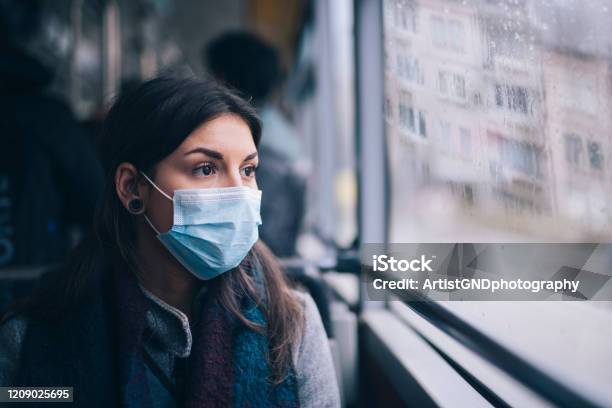 Worried Woman With Protective Face Mask In Bus Transport Stock Photo - Download Image Now