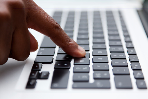 Female finger typing on computer keyboard