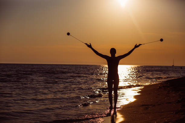 istock Young woman exercising at the beach 1209026324