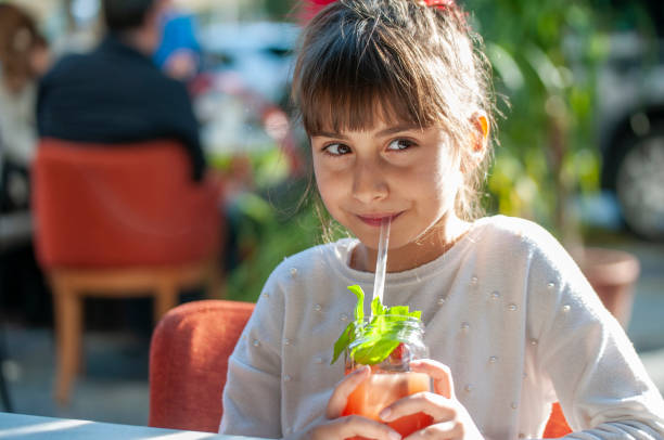 istock Cute girl drinking cocktail 1209026805