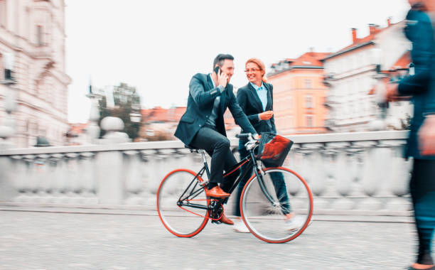 istock Two business people commuting by bicycles 1209027024